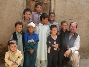 Udo Stolte takes a picture with some orphans.